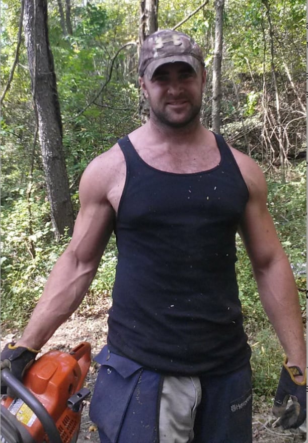 Matt Keddie in the woods with a chainsaw, around 2015.